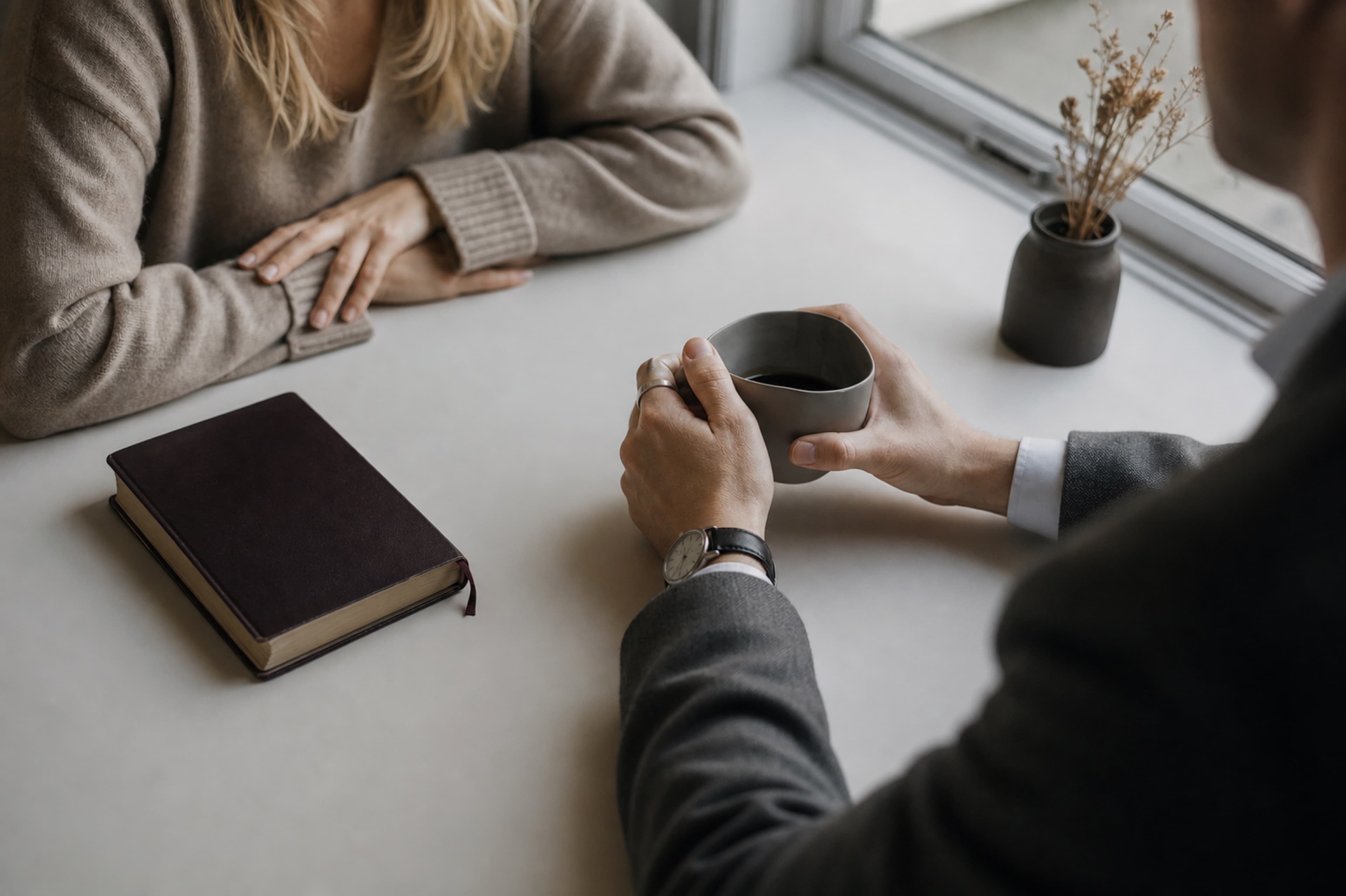 Counsellor in conversation with a client over coffee